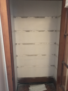 wooden closet shelf supports removed from a wall
