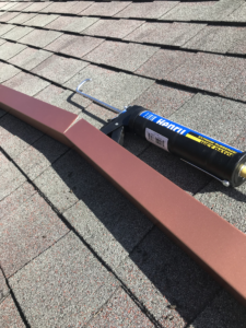 roof-rain-diverter-being-sealed-with-roof-sealant