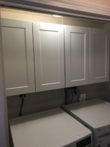 wall-cabinets-hanging-above-washer-and-dryer-machines