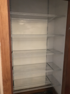 freshly painted closet with five new adjustable shelves