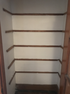 old closet shelves removed from their supports