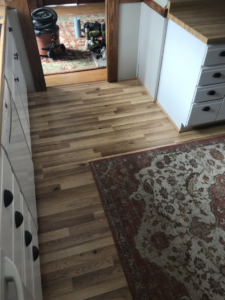 shoe molding installed on top of laminate flooring in a kitchen
