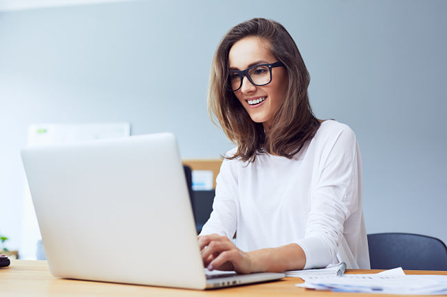 happy homeowner on laptop